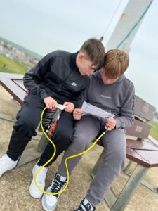 Oscar and Friend Reading Water Rocket Instructions