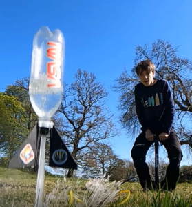 Boy launching water rocket close up